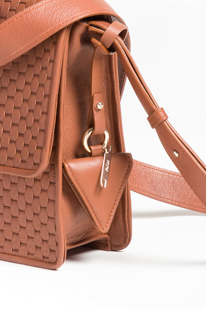 Triangular brown leather keychain with strap and metal ring on white background.