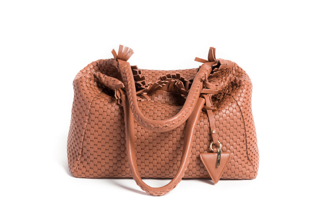 Elegant brown woven leather handbag with double handles and a decorative tassel detail.