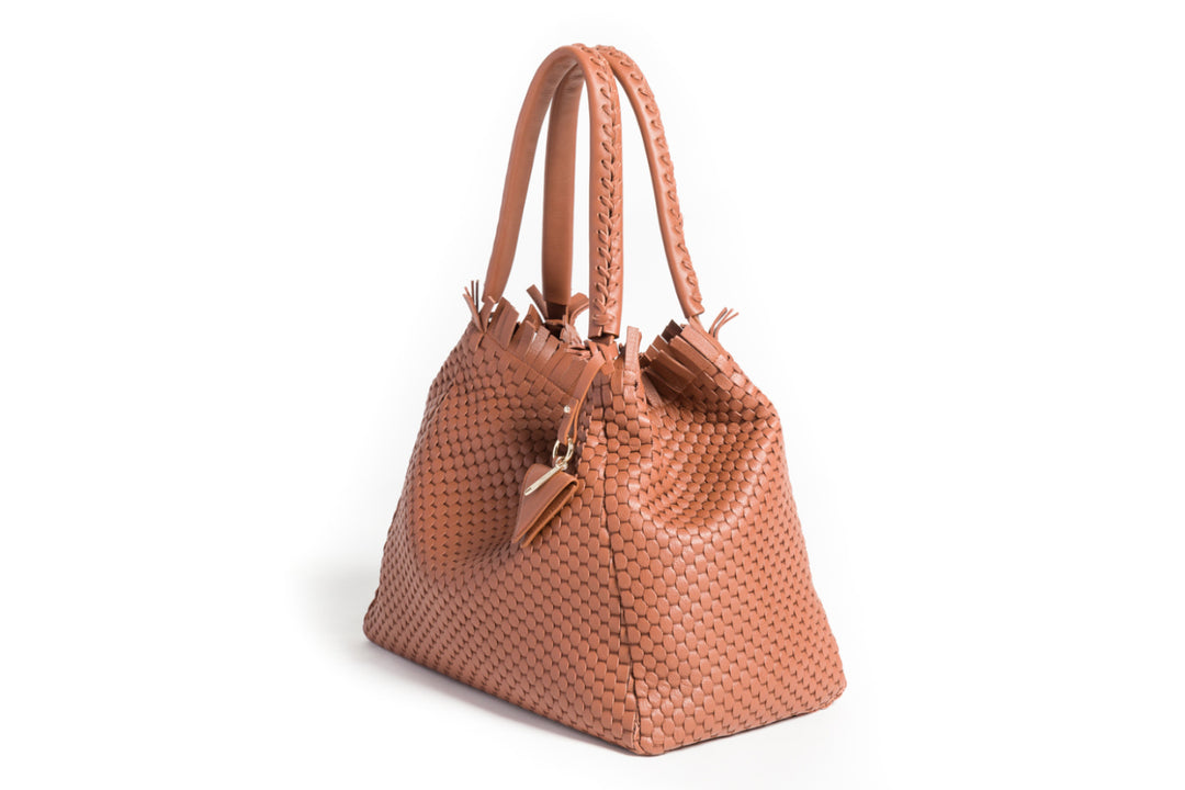 Elegant brown woven leather handbag with double handles and a decorative tassel detail.