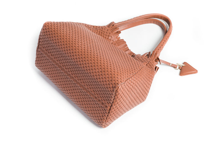 Elegant brown woven leather handbag with double handles and a decorative tassel detail.