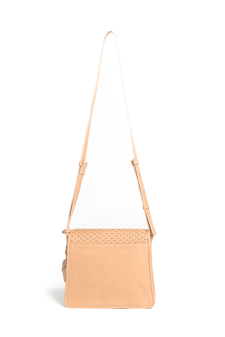 Tan woven leather crossbody bag with gold clasp and adjustable strap on white background.