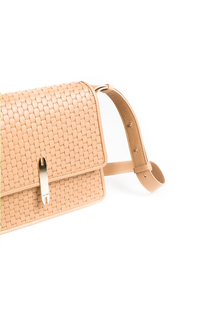 Tan woven leather crossbody bag with gold clasp and adjustable strap on white background.