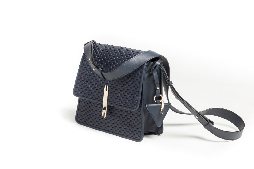 Elegant blue woven leather handbag with adjustable strap and gold-tone clasp.