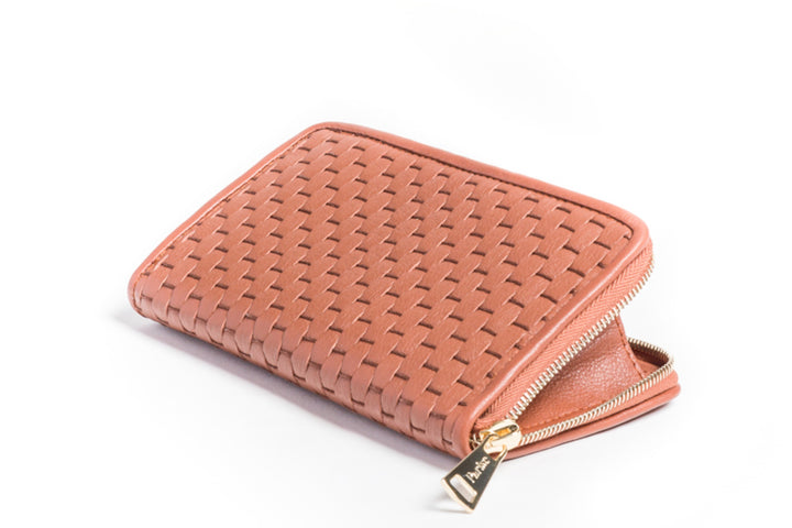 Elegant pink woven zippered wallet on white background.