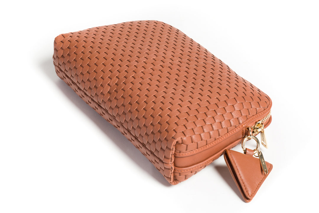 Women's brown woven leather crossbody bag against white background.