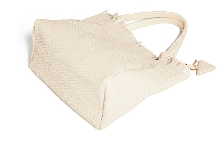 Cream woven handbag with leather straps and tassel detailing.