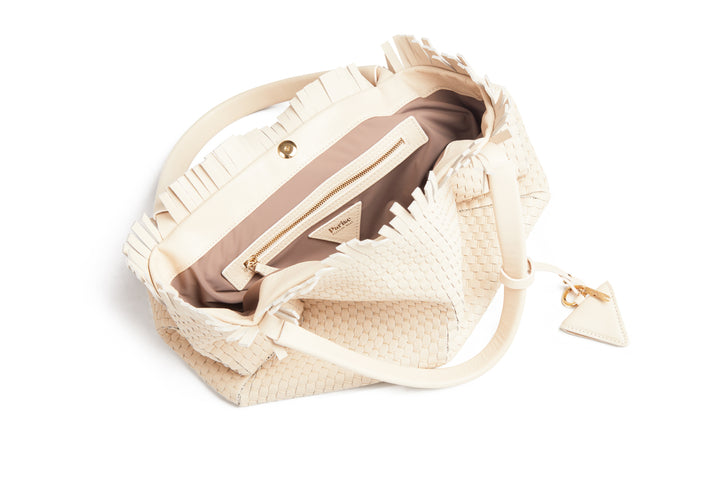 Cream woven handbag with leather straps and tassel detailing.