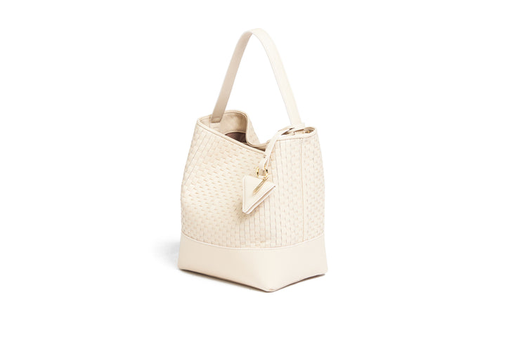 Elegant beige woven leather handbag with gold accents and adjustable strap.