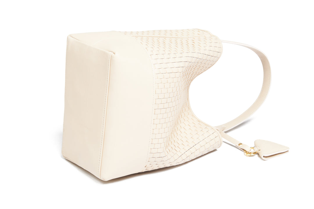 Elegant beige woven leather handbag with gold accents and adjustable strap.