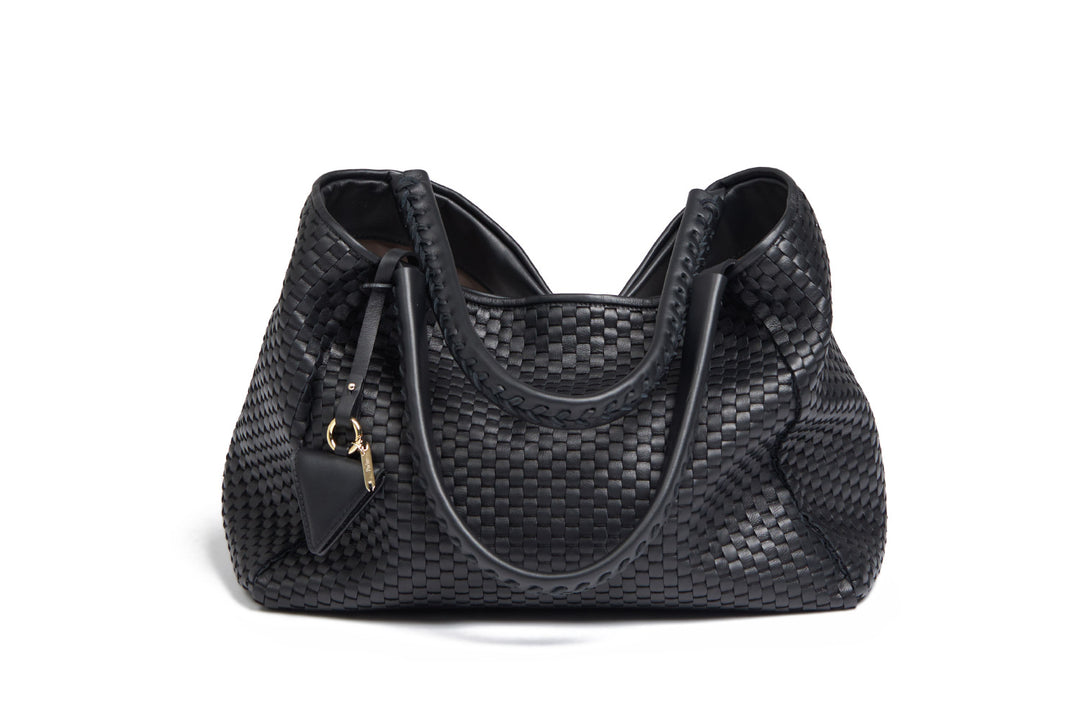 Black woven leather handbag with gold zipper and decorative tassel.