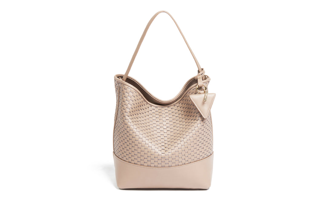 Beige woven leather handbag with adjustable strap on white background.