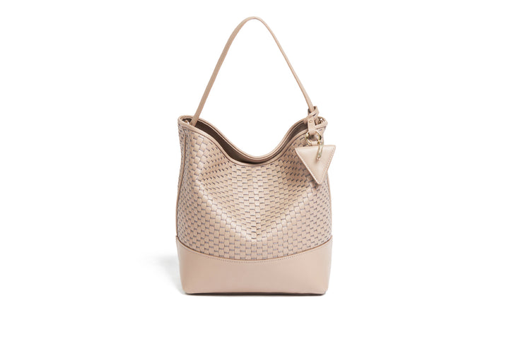 Beige woven leather handbag with adjustable strap on white background.