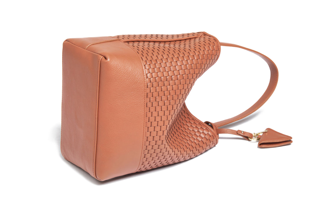 Elegant brown woven leather handbag with adjustable strap and minimalist design.