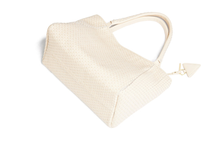 Elegant woven beige handbag with shoulder strap.