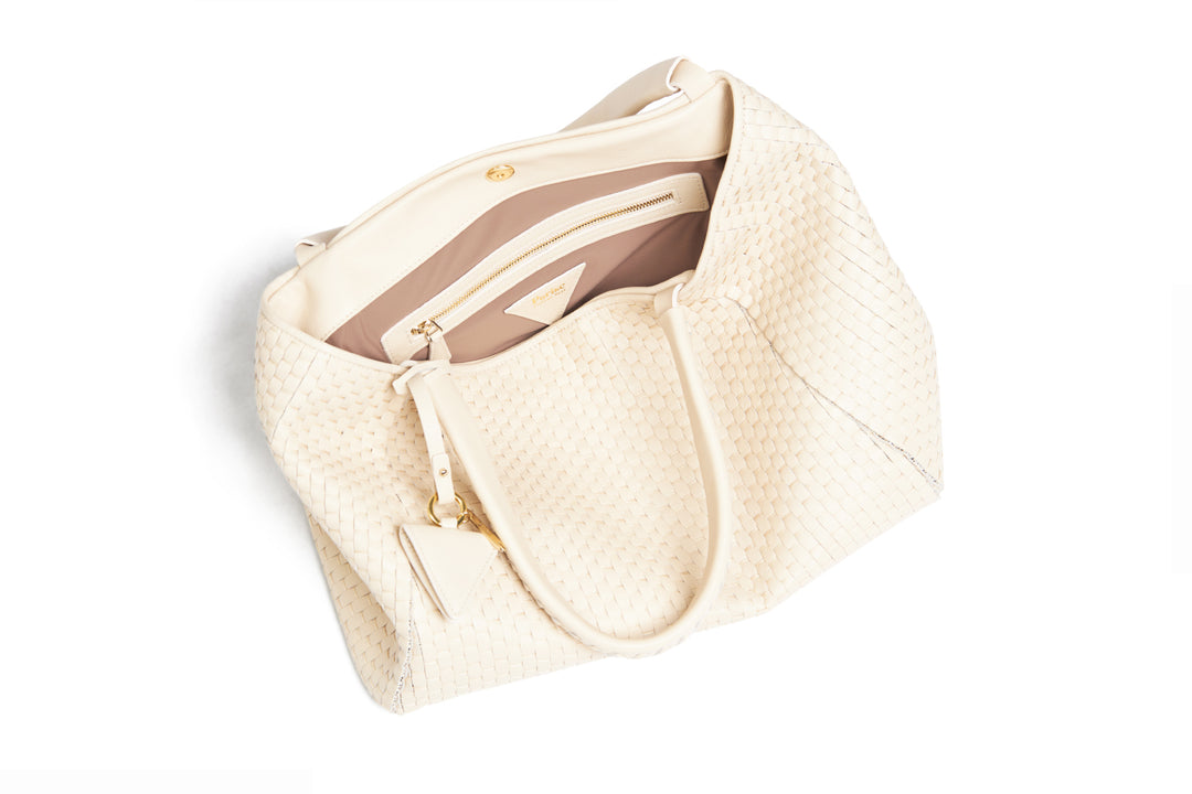 Elegant woven beige handbag with shoulder strap.