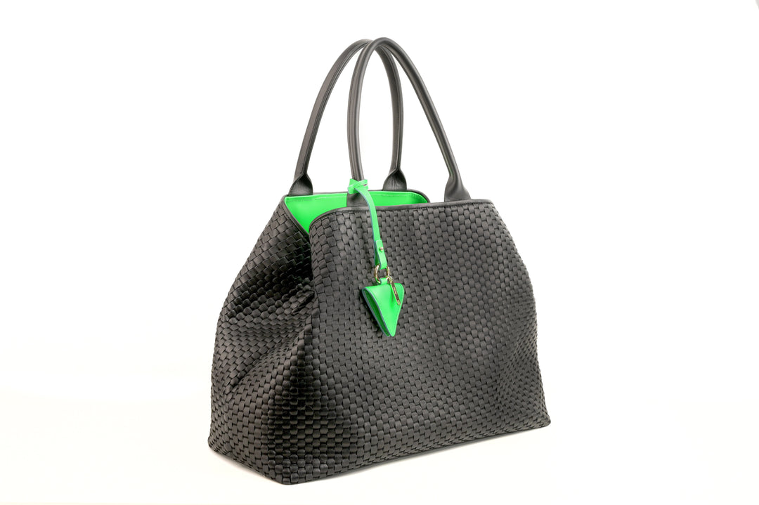 Elegant black woven handbag with neon green keychain tag.