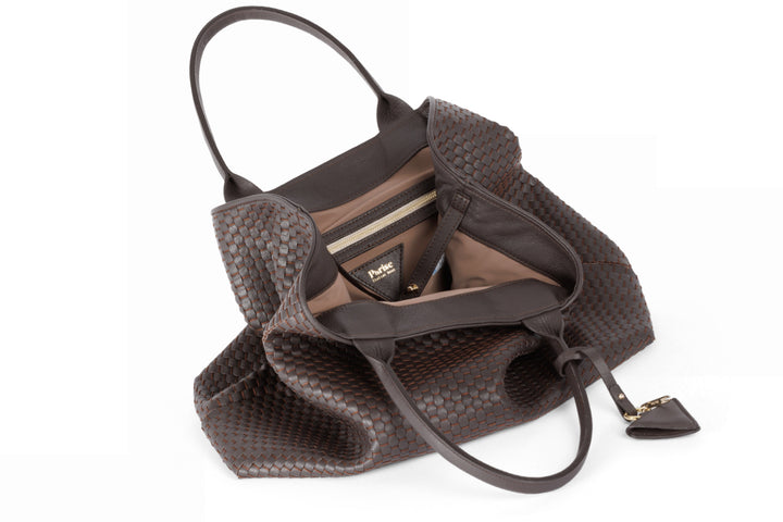 Brown leather woven tote bag with handles and a triangular charm.