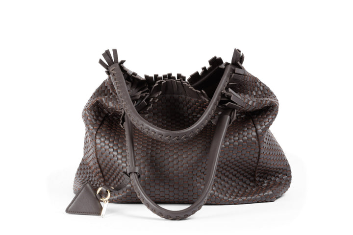 Elegant brown woven leather handbag with braided handles and fringe detailing.