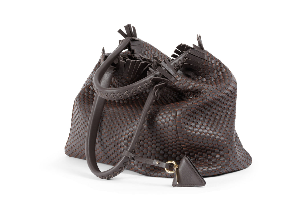 Elegant brown woven leather handbag with braided handles and fringe detailing.