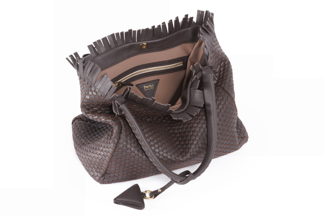 Elegant brown woven leather handbag with braided handles and fringe detailing.