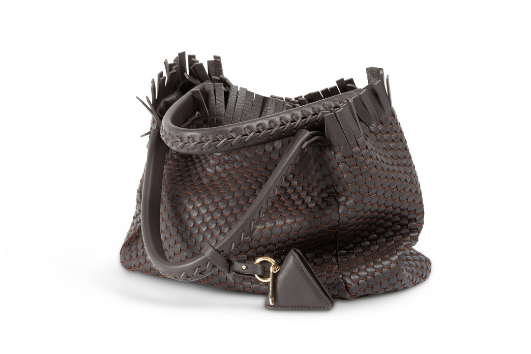 Brown woven leather handbag with tassel accents and dual handles.