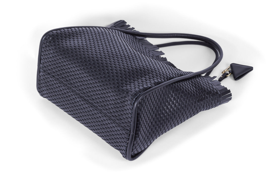 Woven leather handbag with triangular metal detail.