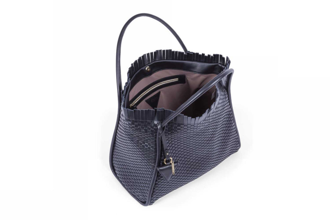 Woven leather handbag with triangular metal detail.