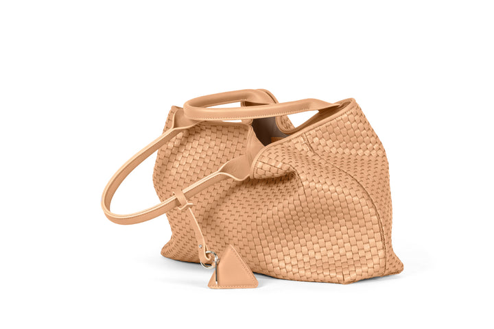 Woven beige leather tote bag with dual handles and keychain accessory.