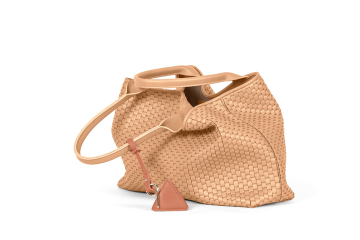 Tan woven leather handbag with handles and a triangular accent.