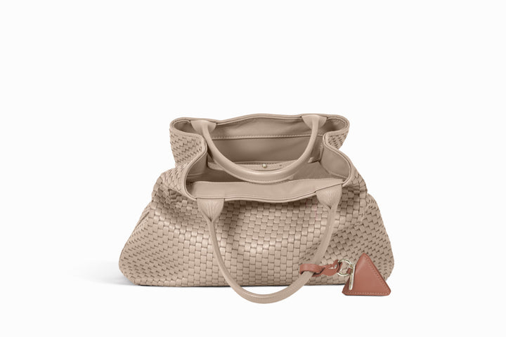 Elegant beige woven tote bag with leather handles and accent tag.