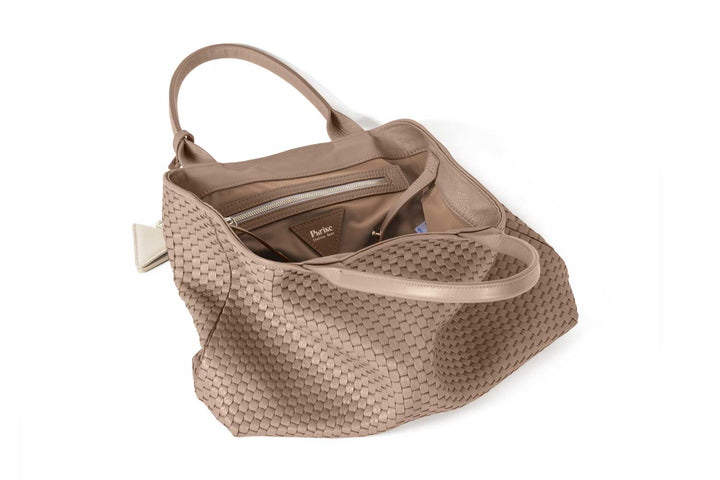 Elegant beige woven leather tote bag with handles and a decorative tag.