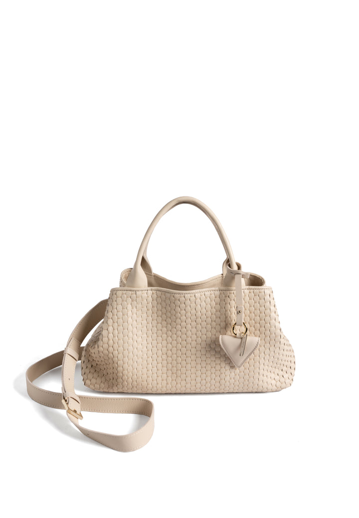 Elegant cream woven leather handbag with gold charm and sturdy handles, isolated on white background.