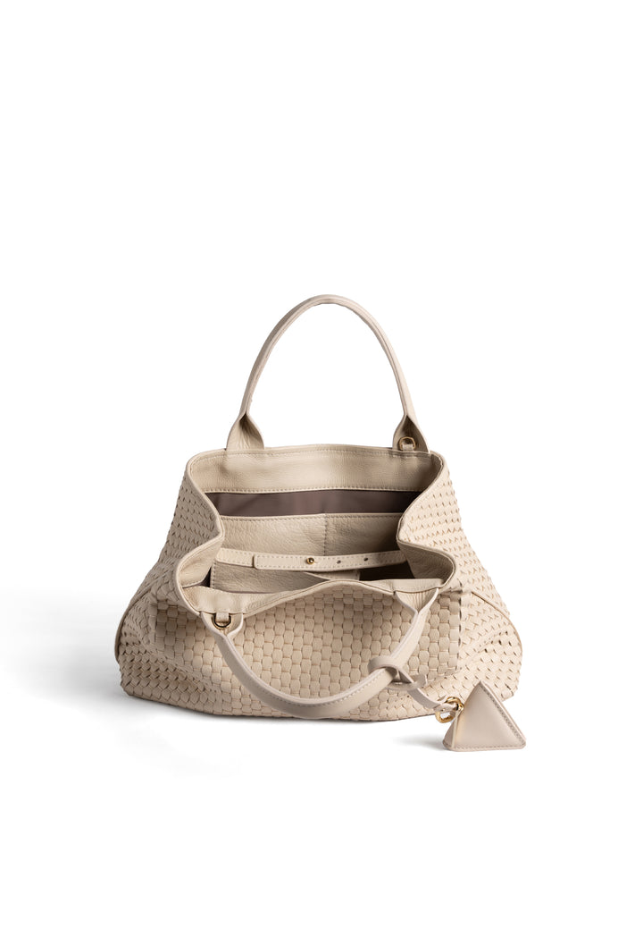 Elegant cream woven leather handbag with gold charm and sturdy handles, isolated on white background.