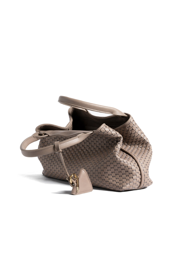 Alt text: Elegant woven leather handbag in taupe with a triangular pendant on a white background