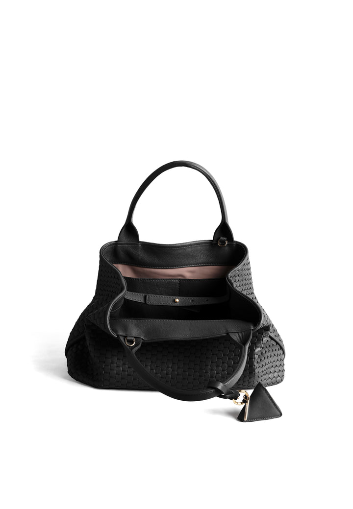 Black woven handbag with leather handles and a small attached accessory.