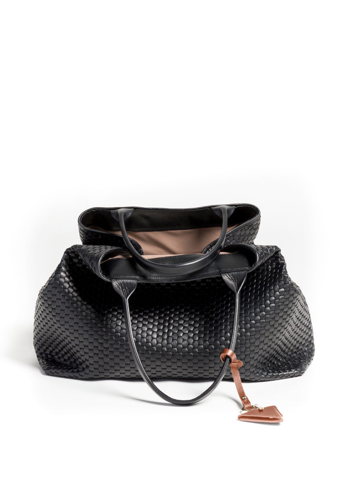 Elegant black woven leather handbag with decorative brown triangle tag.