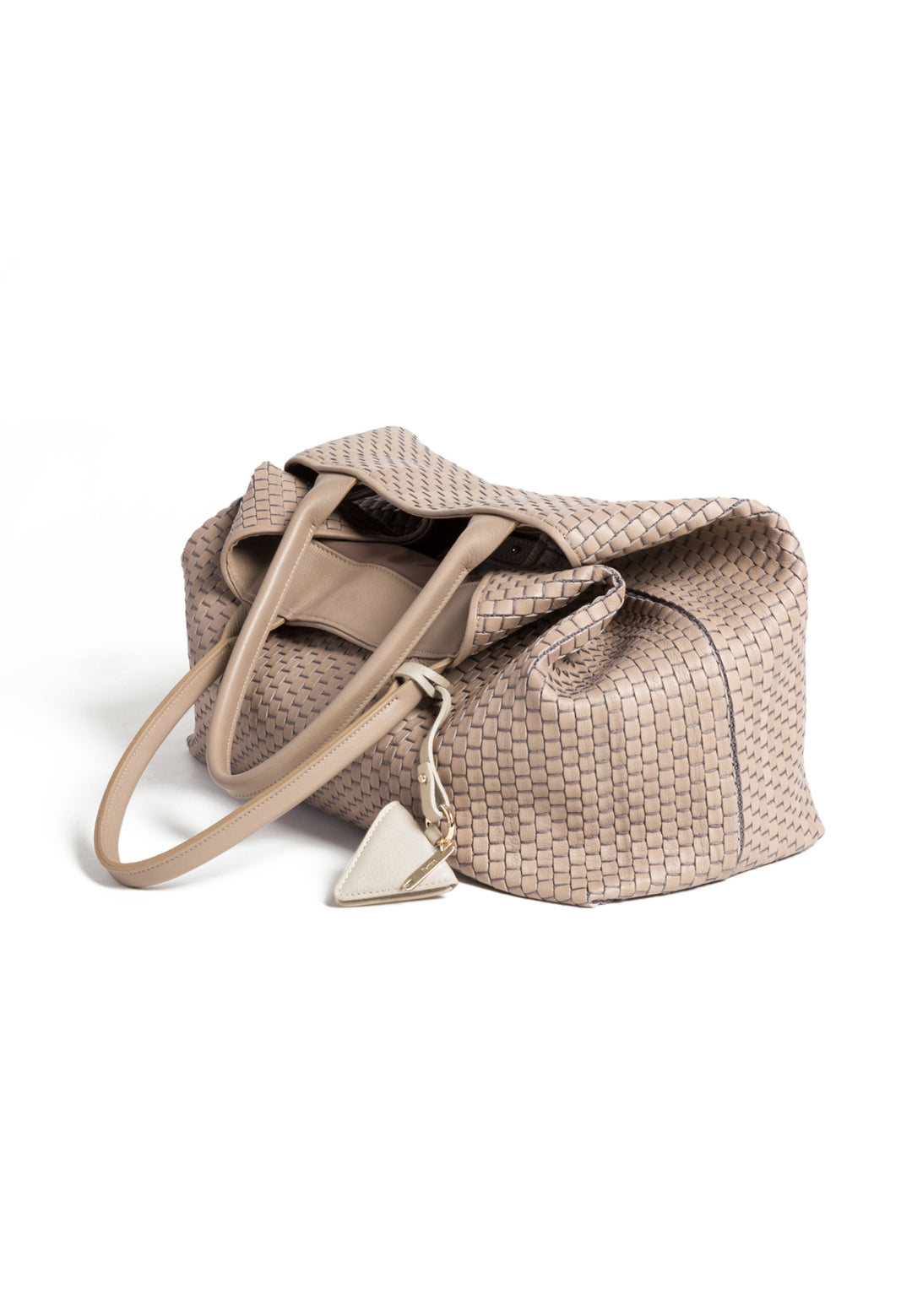 Elegant beige woven handbag with triangular charm and dual handles.