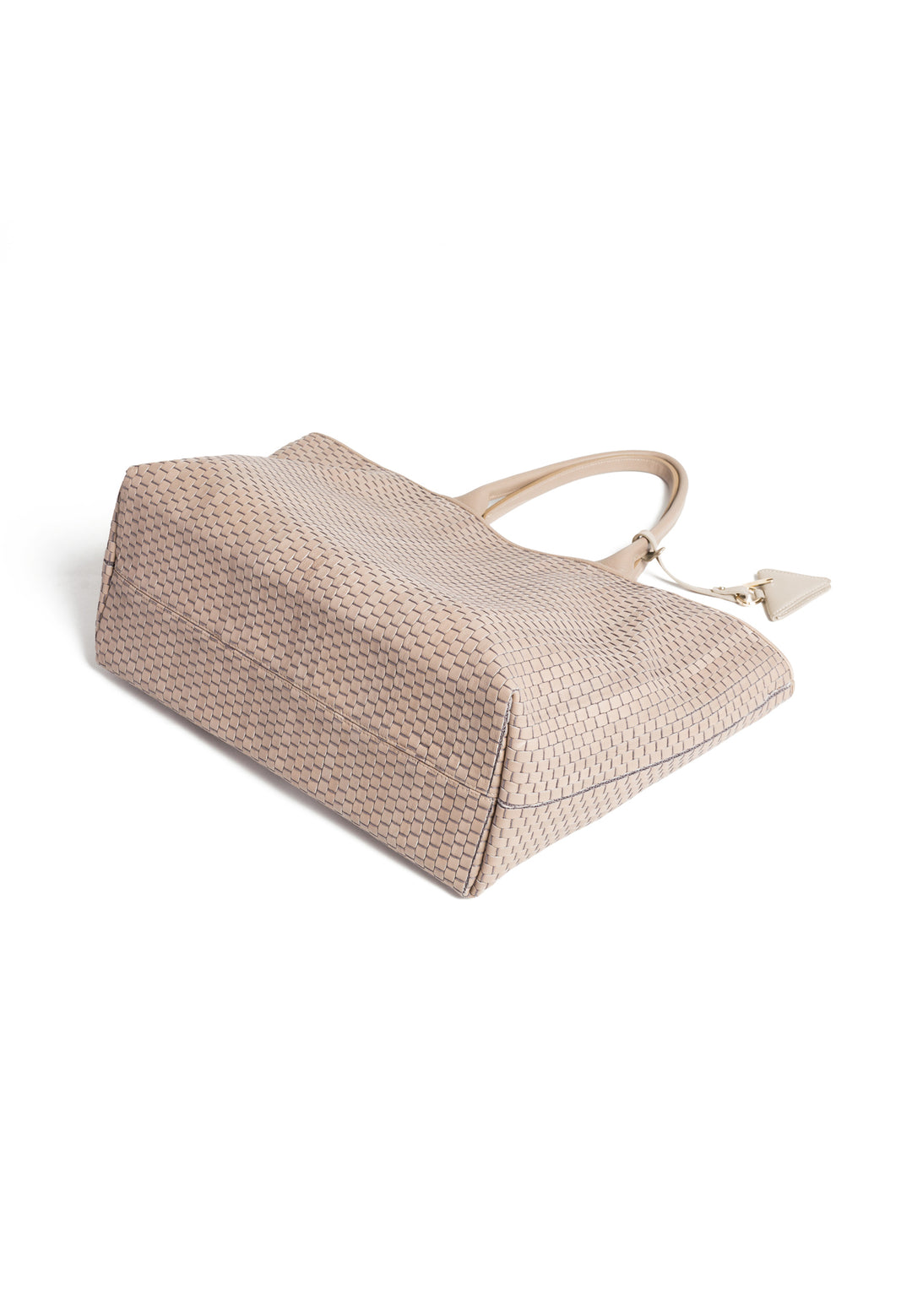 Elegant beige woven handbag with triangular charm and dual handles.