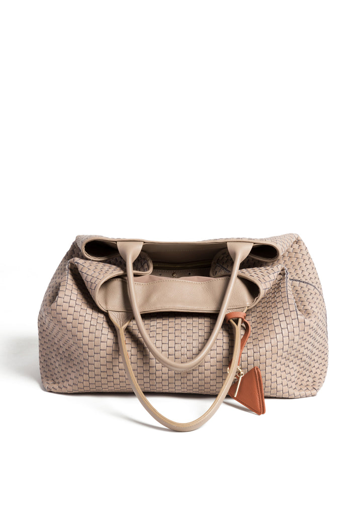 Woven beige leather tote bag with handles and a triangular leather charm.