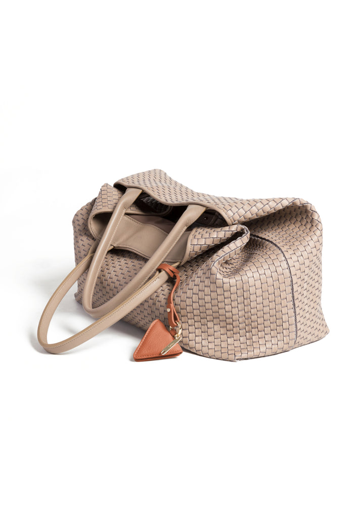 Woven beige leather tote bag with handles and a triangular leather charm.