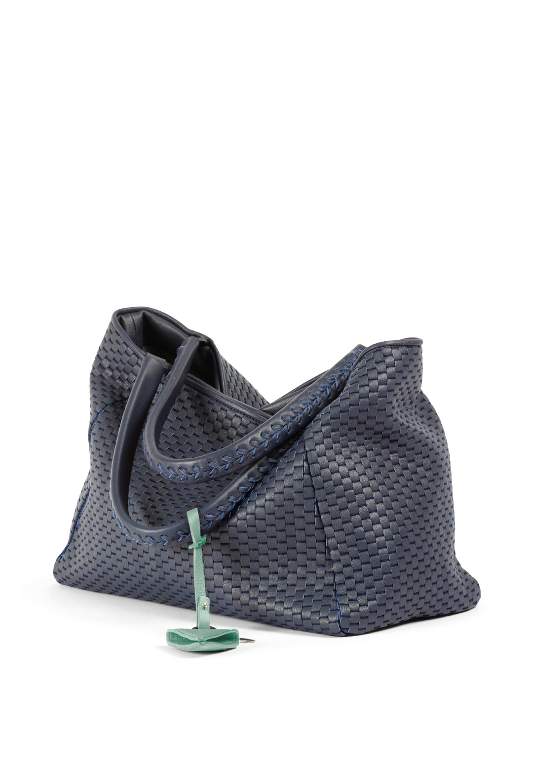 Elegant blue woven leather handbag with a green charm.