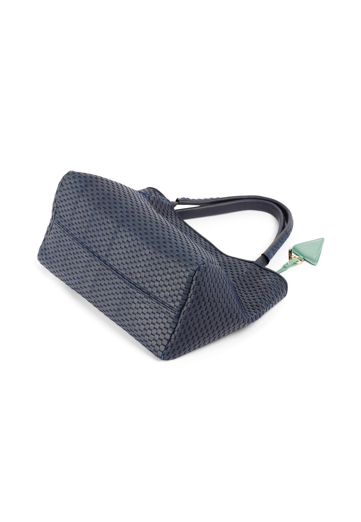 Elegant blue woven leather handbag with a green charm.