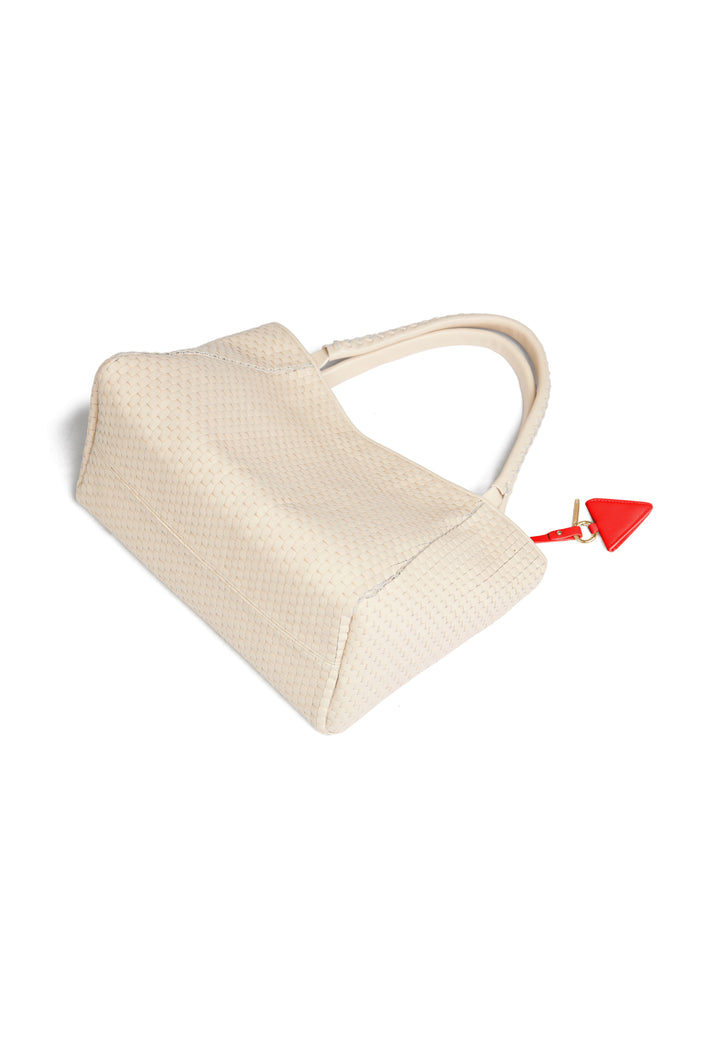 White woven handbag with red geometric accent tag.