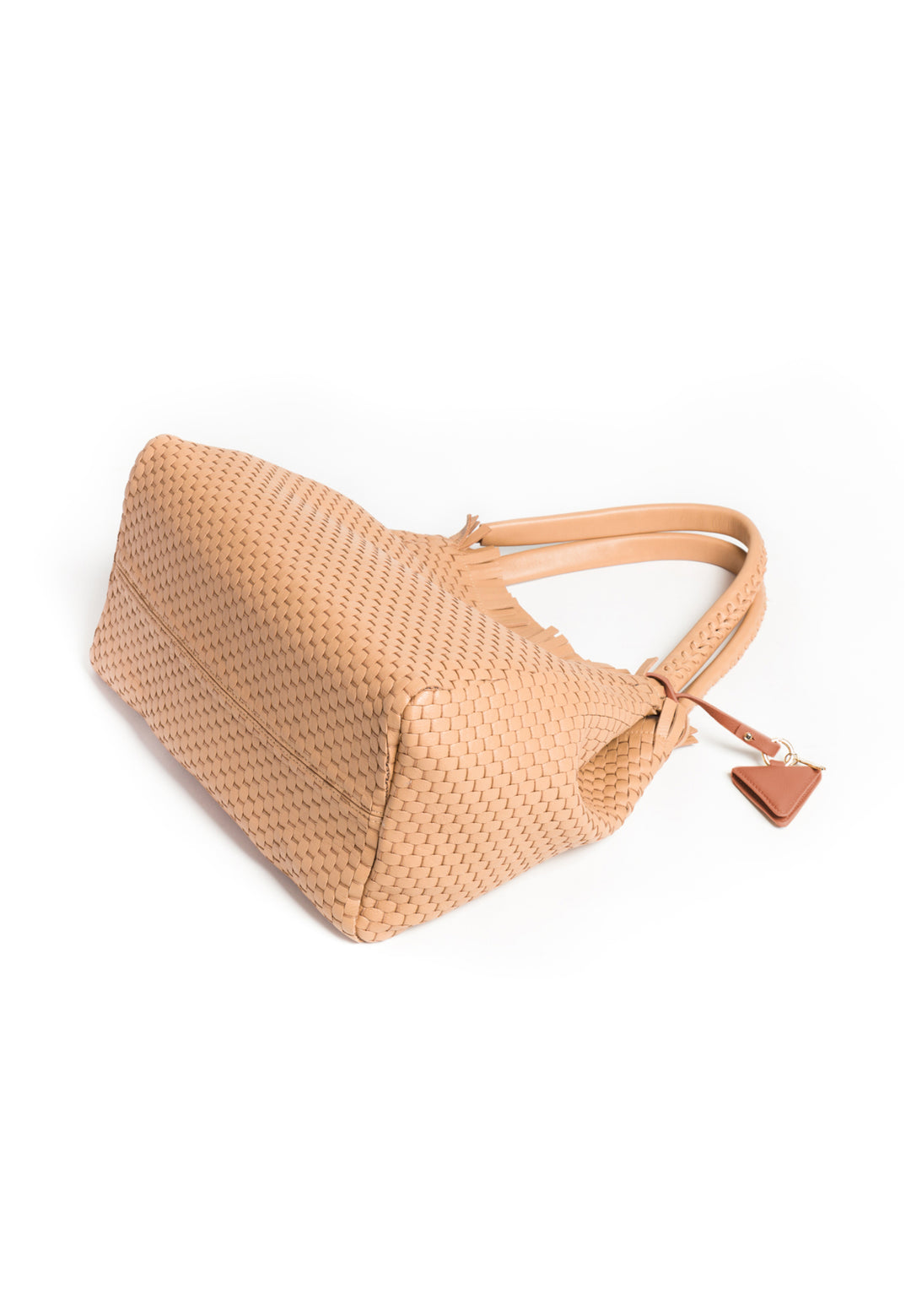 Handcrafted beige woven leather handbag with braided handles and decorative accent tag.