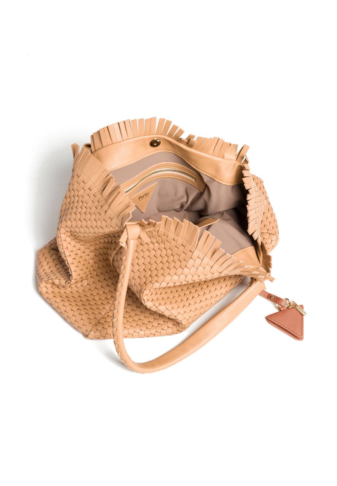 Handcrafted beige woven leather handbag with braided handles and decorative accent tag.