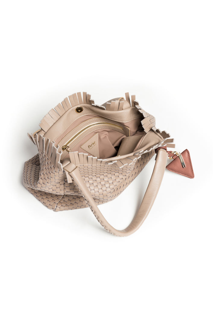 Woven beige handbag with top handles and decorative leather tag.