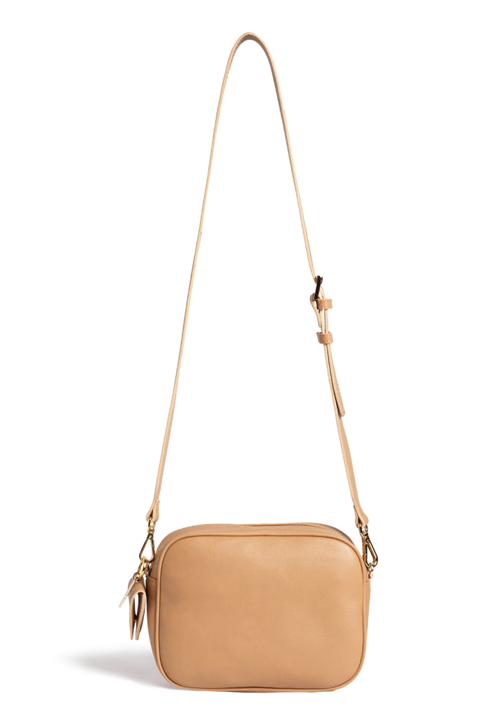 Tan woven crossbody bag with adjustable strap.