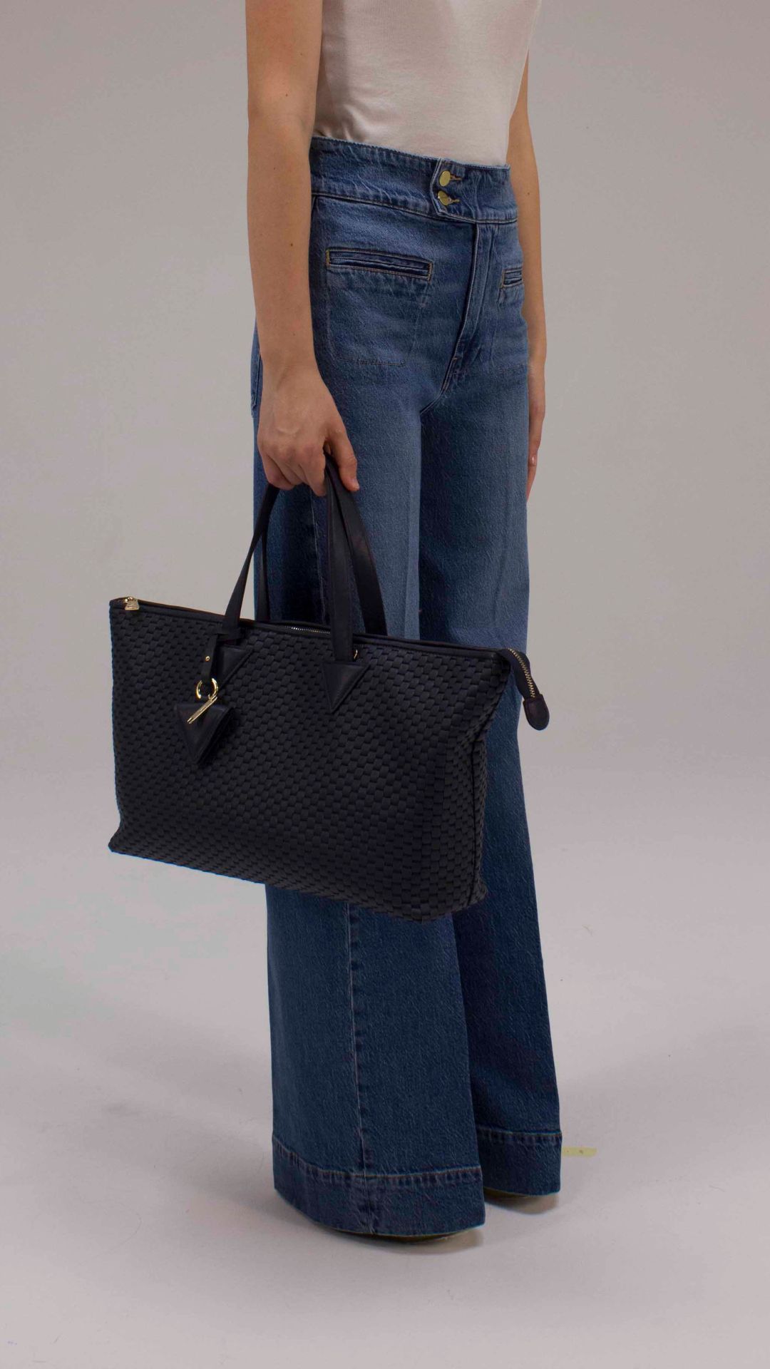 Elegant navy blue woven leather handbag with detachable shoulder strap.