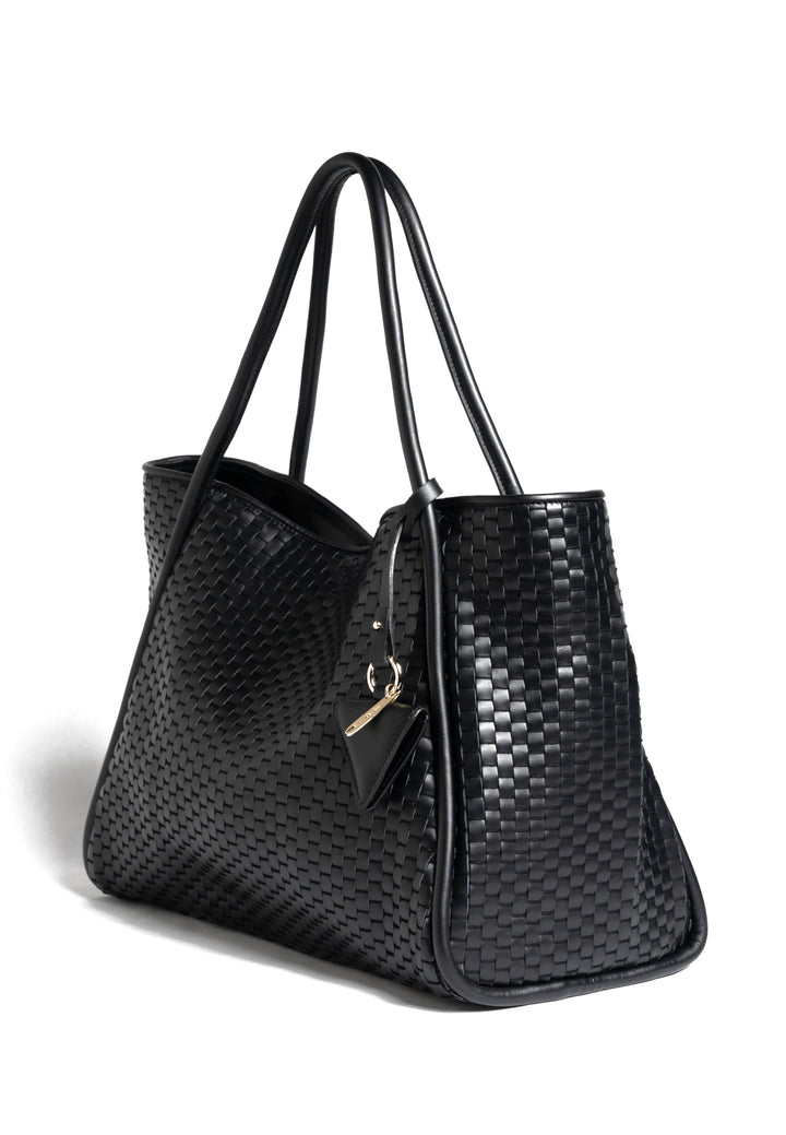 Black woven leather tote bag with handles, featuring a small attached accessory.