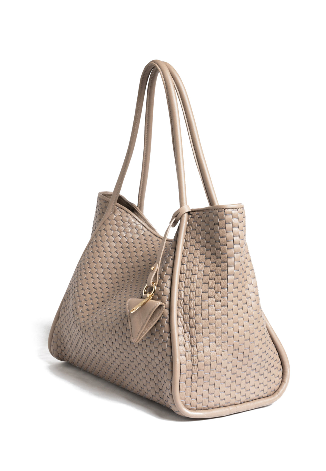 Woven beige handbag with long handles and attached accessory on white background.